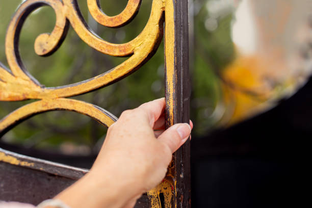 istock A woman's hand opens a golden forged door. Enter another life 1403032651