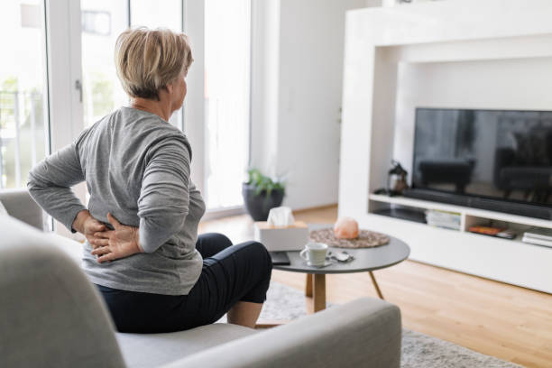 istock Elderly woman at home with back pain 1403033523