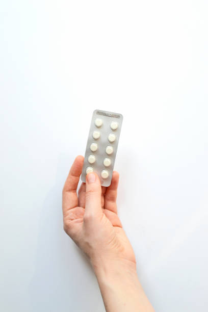 istock Packaging pills in hand close-up on a white background. 1403034339