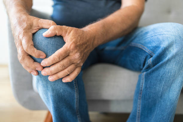 istock Senior holding his painful knee 1403034991