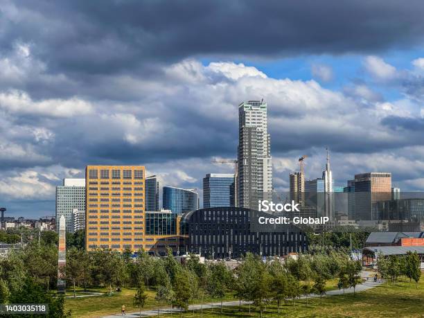Brussels Belgium May 19 2022 Cityscape Of Brussels City Skyscrapers In Summer On A Cloudy And Sunny Day With A Dramatic Sky Green Park In The Foreground Stock Photo - Download Image Now