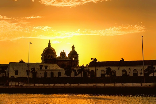 The church of Sanctuario de San Pedro Claver lit up by a golden sunset in Cartagena, Colombia