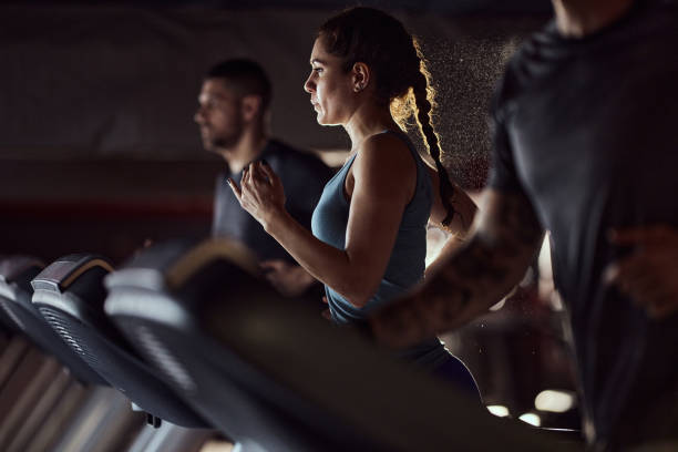 istock Athletic woman warming up on treadmill in a gym. 1403037652