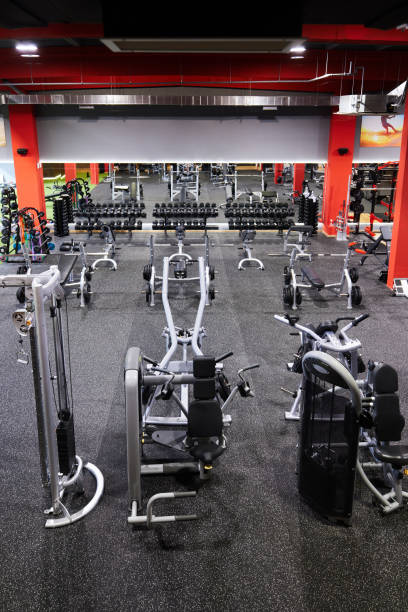 Large group of exercise machines and equipment in a gym.