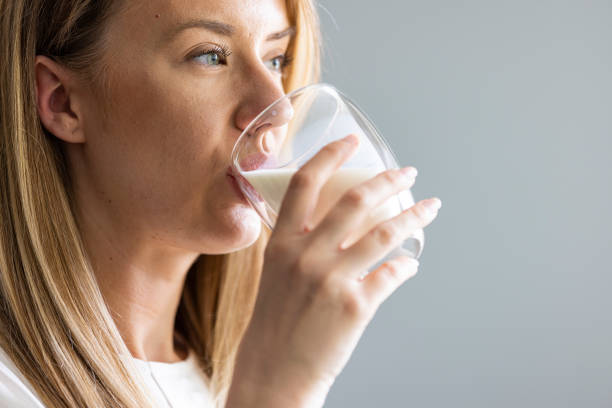 istock Happy young woman drinking milk. 1403039224