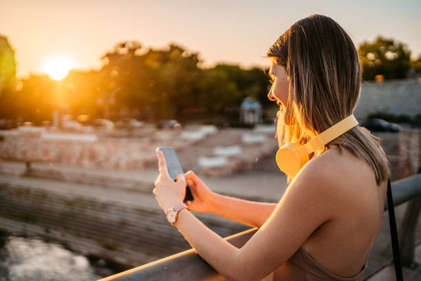 istock Young Woman Taking A Picture On The Bridge 1403039416