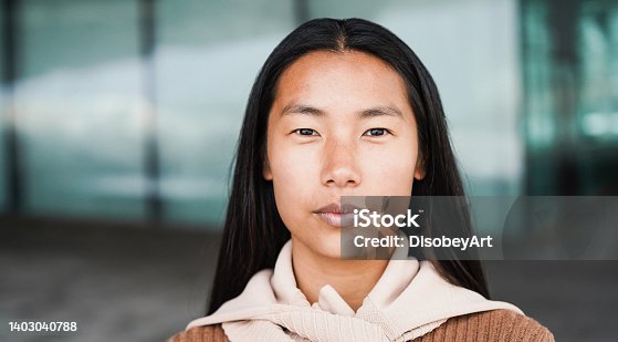 istock Portrait of asian girl looking at camera outdoor - Focus on face 1403040788