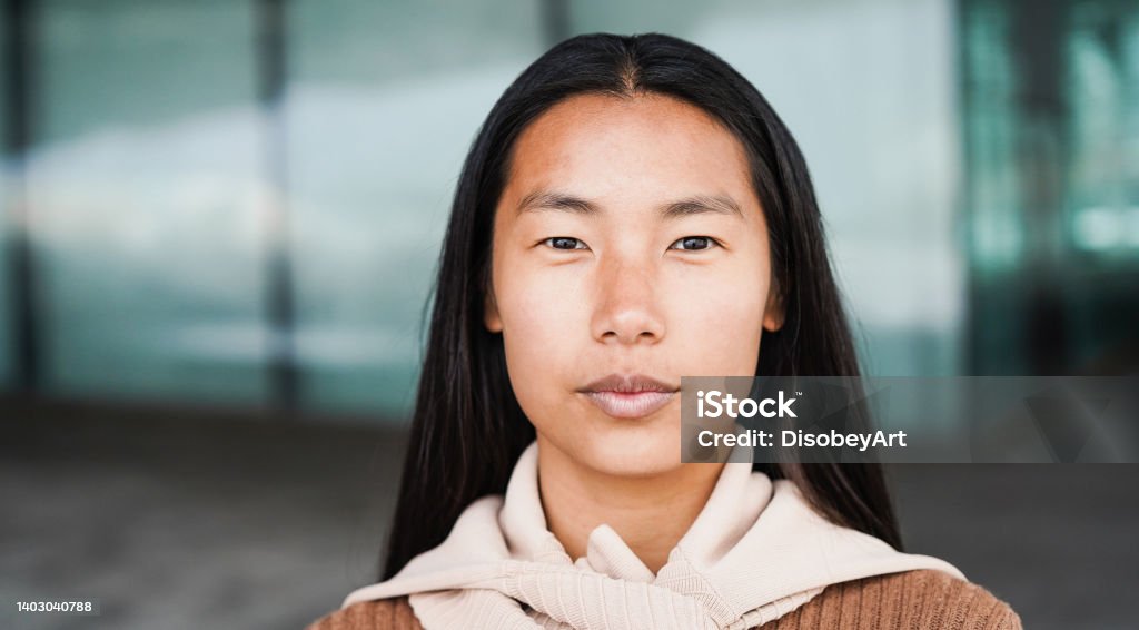 Portrait of asian girl looking at camera outdoor - Focus on face Portrait Stock Photo