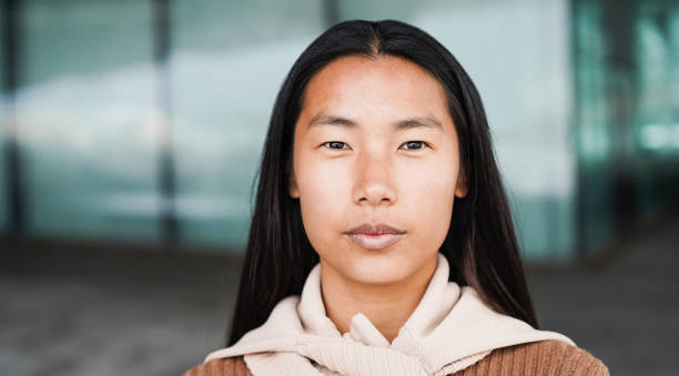 portrait of asian girl looking at camera outdoor - focus on face - face close up imagens e fotografias de stock