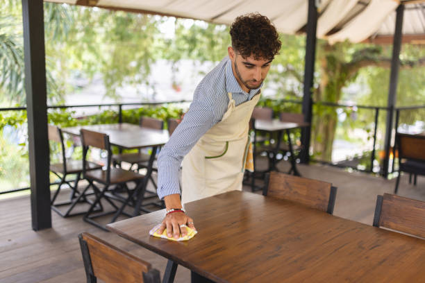 istock Waiter cleaning the table at the coffee shop 1403041125