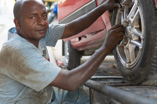 African Mechanic Working In Auto Repair Shop