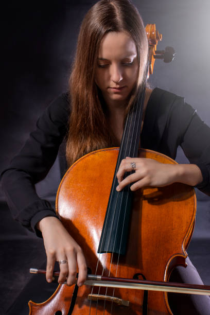 istock Beautiful girl cellist playing sonata 1403045101
