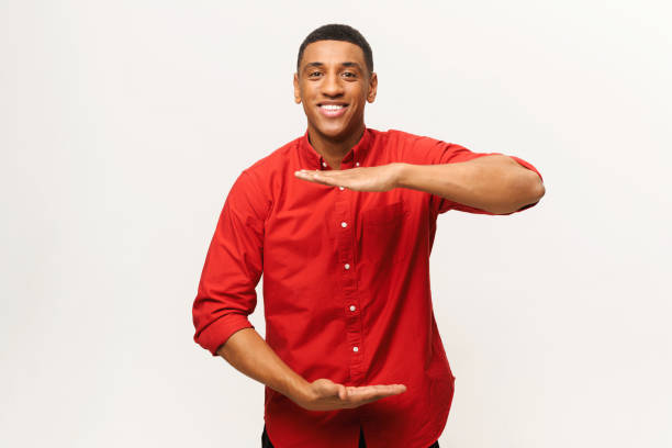 istock Positive Aferican-American young man measuring with palms empty space 1403045783