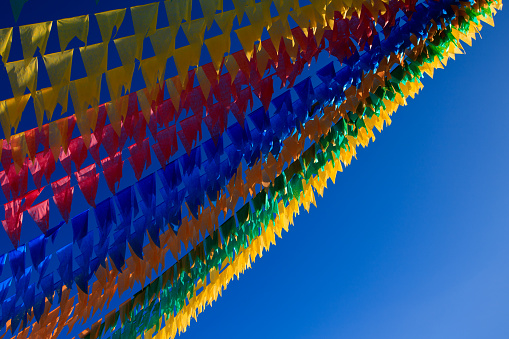Typical flags in Spain used to decorate streets and squares for an upcoming religious festival (fiesta).