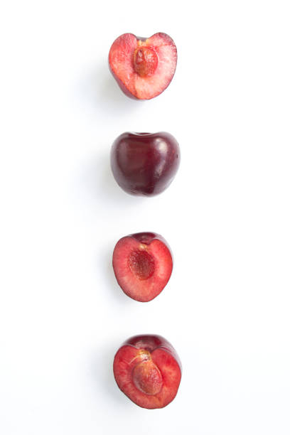 istock Ripe cherry cut in half, on a white background, macro shot. Copy space 1403047734