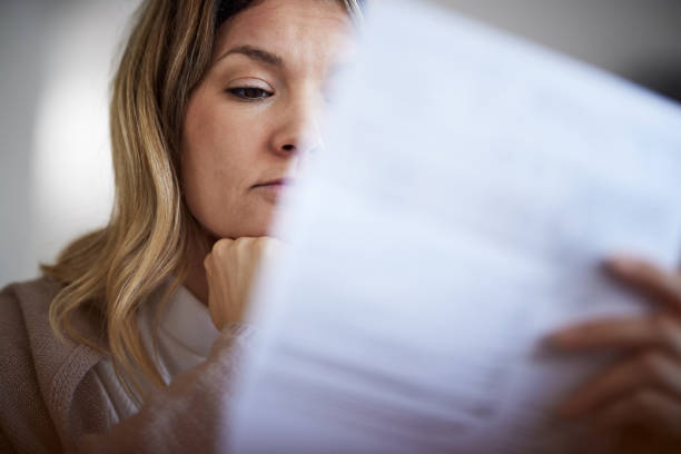 istock Young woman going through her financial bills at home. 1403047755