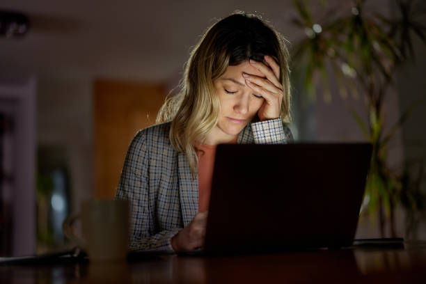 istock Exhausted businesswoman working on computer late in home office. 1403048373