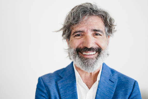Business senior man smiling on camera - Main focus on face