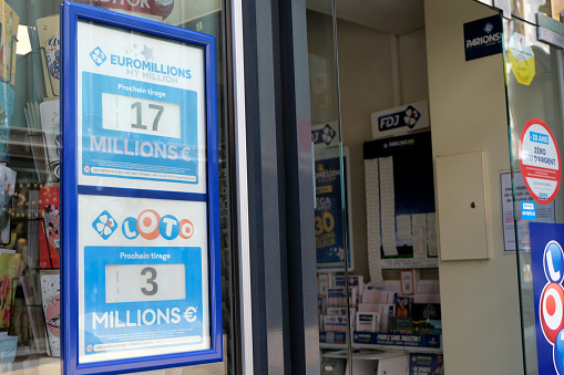 Vannes, France, June 14, 2022: Signs of Loto and Euromillions winnings on the window of a tobacco shop in France