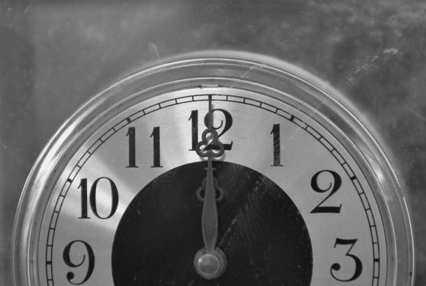 istock old long and short clockwises pointing on twelve o' clock at noon or midnight background 1403051764