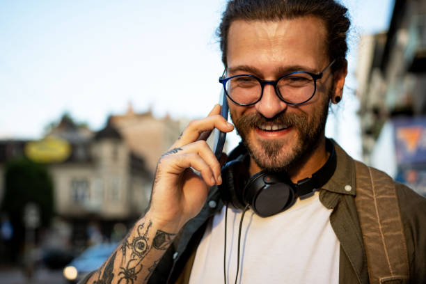 istock Young handsome man talking on phone outdoors 1403052897