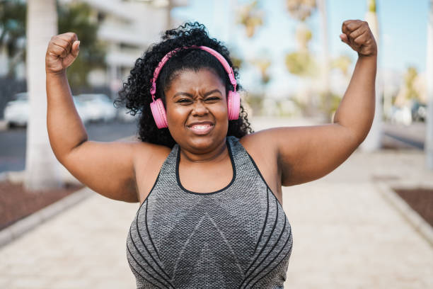 istock Happy curvy african woman doing workout routine outdoor - Focus on face 1403054357