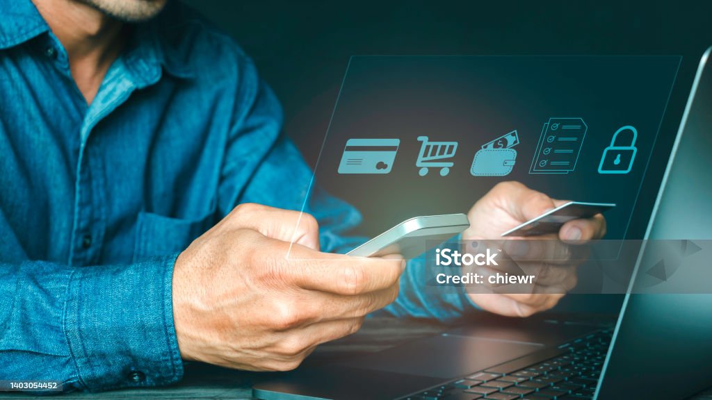 Man using mobile phone and credit card paying via mobile banking app for online shopping with technology icon digital banking. Network Security Stock Photo