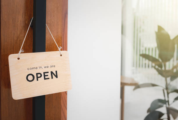 istock open sign hanging on wood door 1403057152