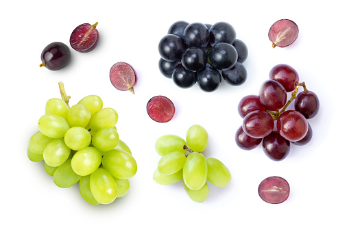 Various grapes fruit and half sliced isolated on white background. Top view. Flat lay.