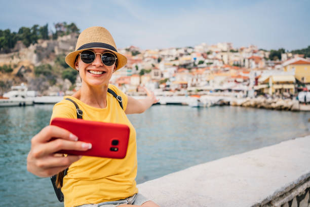 istock Young woman vlogging from the seaside 1403057914
