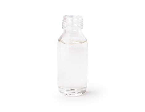 Cold pressed extra virgin coconut oil in glass bottle isolated on white background. Clipping path.
