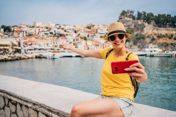 istock Young woman vlogging from the seaside 1403058012