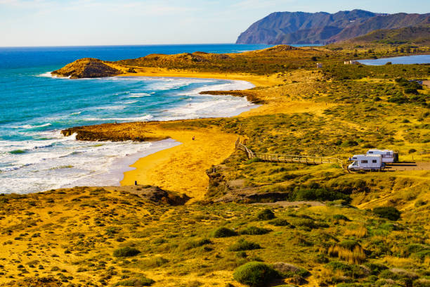 istock Coast view with camper rv camping on sea shore, Spain 1403058019