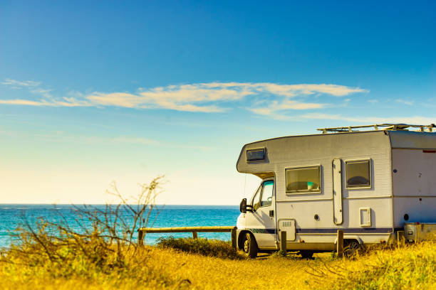 Camper vehicle rv camping on beach sea shore. Spain Murcia region, Calblanque Regional Park.