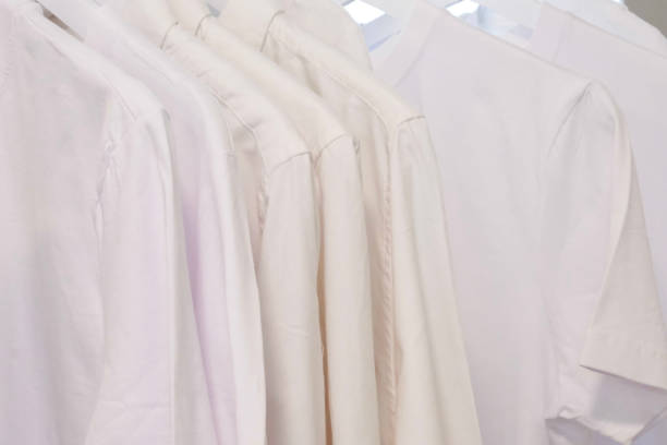 istock White clothes closeup hanging on white hangers. 1403059573