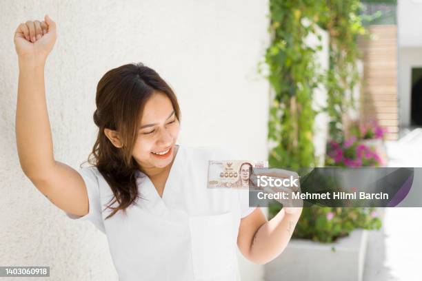 Happy Asian Woman Hand Holding Banknote Stock Photo - Download Image Now - Adult, Adults Only, Asian and Indian Ethnicities