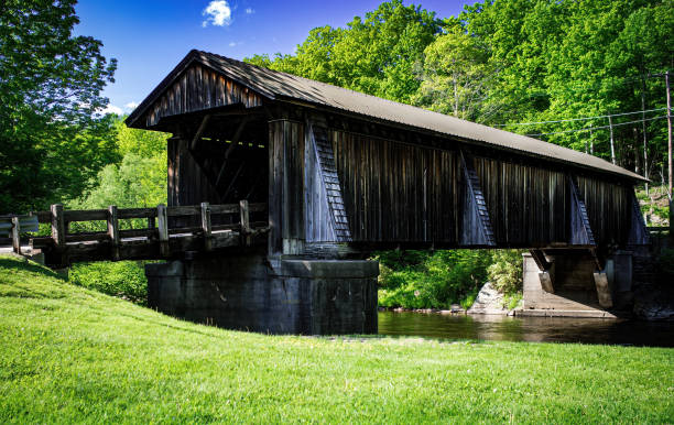 istock Weathered wooden covered bridge in countryside. 1403061989