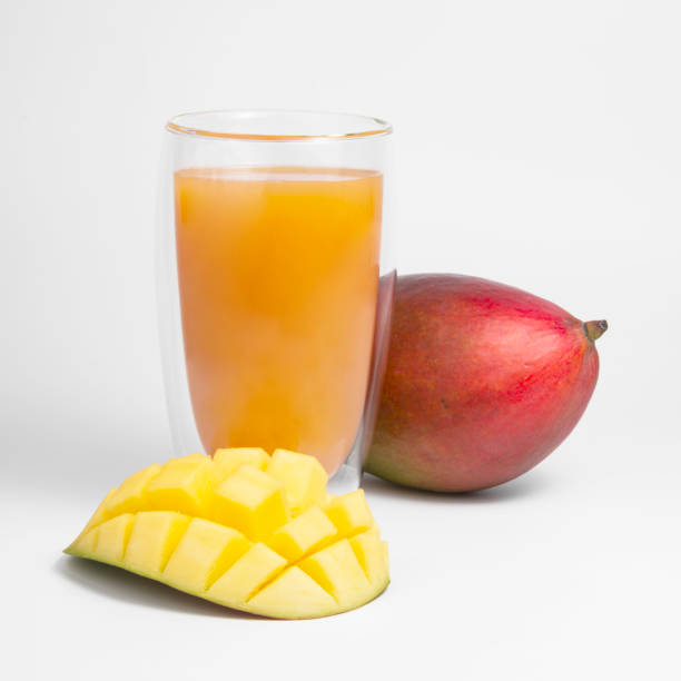 istock Mango fruit juice in glass isolated on the white 1403062768