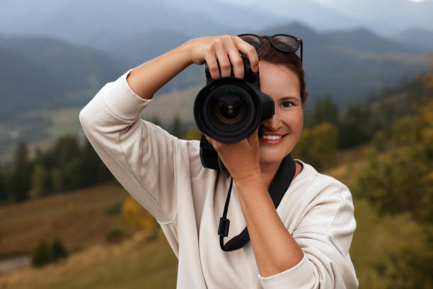 istock Professional photographer taking picture with modern camera in mountains 1403063753