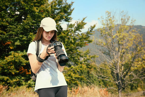 istock Professional photographer with modern camera in mountains. Space for text 1403064023