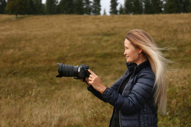 istock Professional photographer with camera in nature. Space for text 1403064097