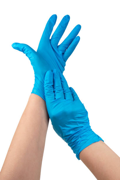 istock Blue nitrile medical gloves on hands isolated on the white 1403065020