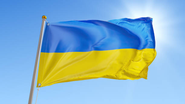 istock 3d render, abstract background with waving blue-yellow Ukrainian flag over the clear blue sky with sunlight 1403066791