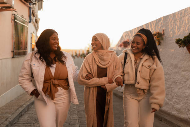 istock Best friends laughing while walking together 1403069964