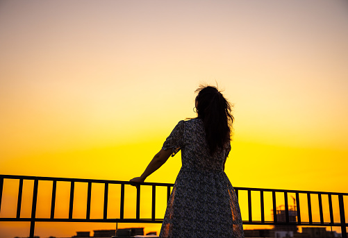 women looking city sunrise