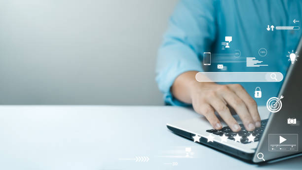 istock businessman Are working on the laptop keyboard to use the search engine optimization tool. 1403072417