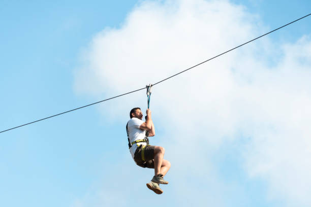 istock Teenager having fun on a zipline blue sky background with copy space 1403072568