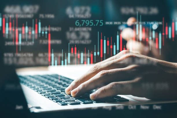 istock Businessman working in modern office, technical price chart and red and green candlestick chart indicator and computer screen background. 1403072575