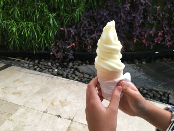 istock kids holding yummy ice cream on marble background. Focus on hand 1403074131