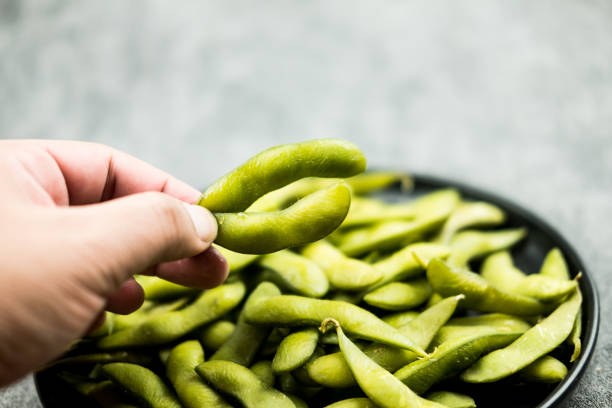 istock Hand-picking up green Japanese soybean 1403075064